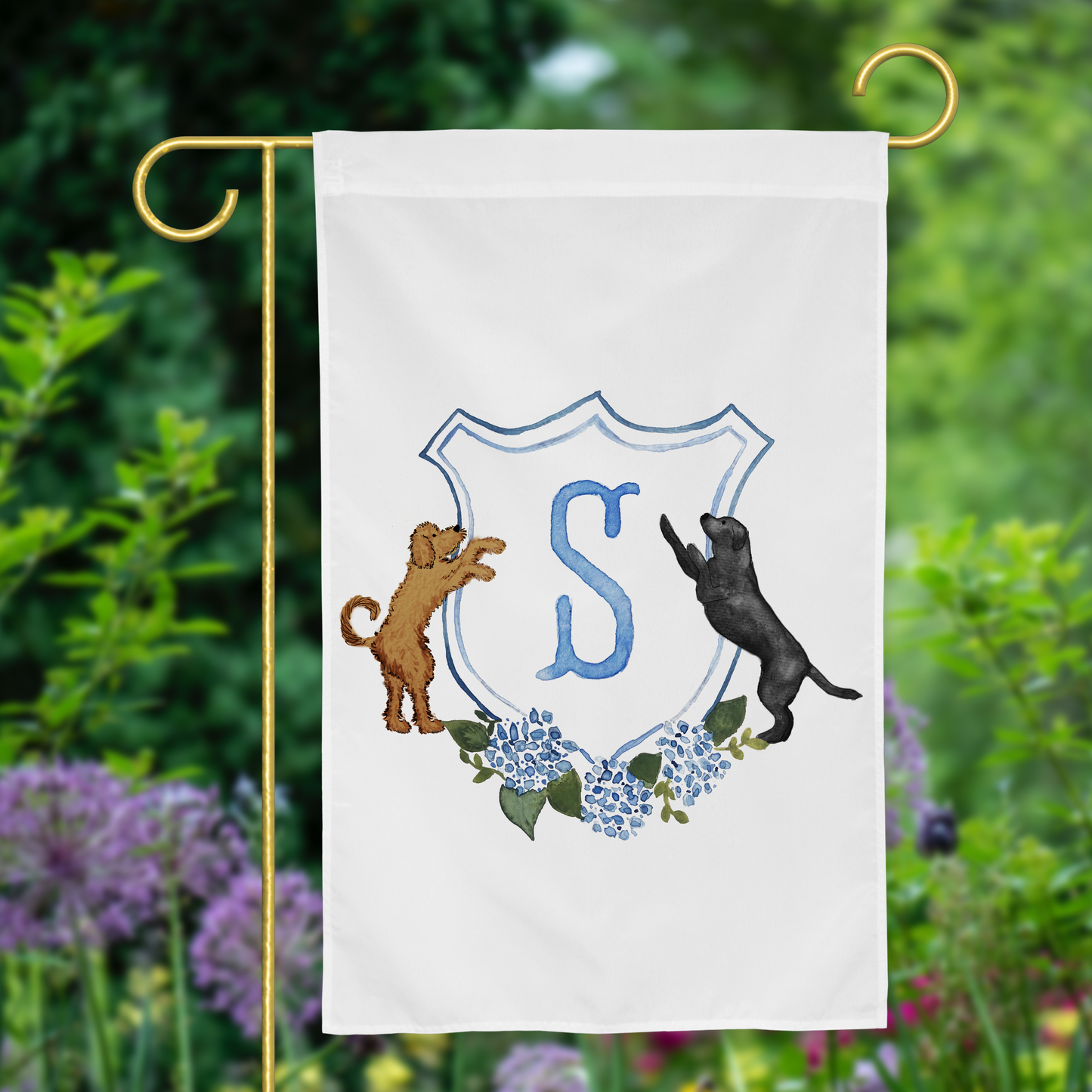 Custom dog garden flag featuring a golden retriever and labrador with family monogram, displayed in garden setting.