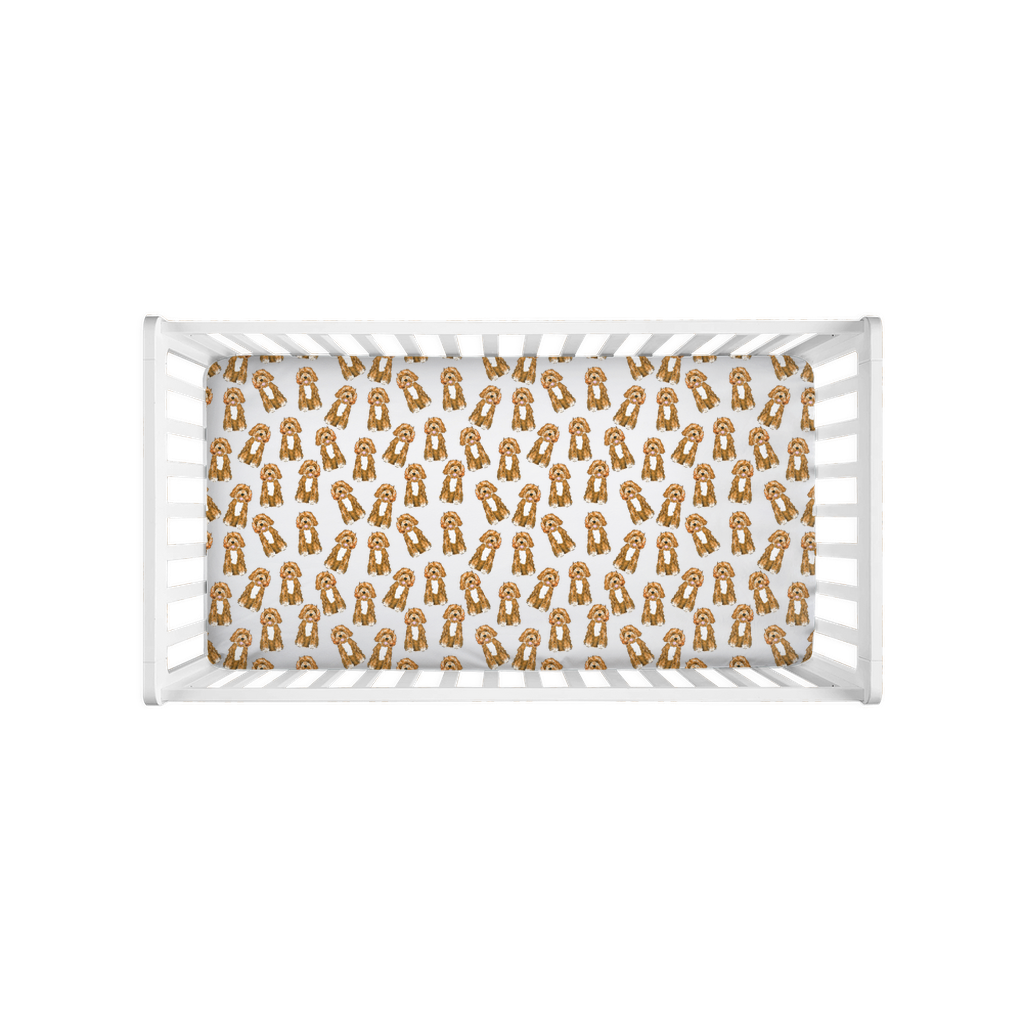 Top view of crib with fitted crib sheet featuring watercolor Apricot and Cream Mini Doodles pattern